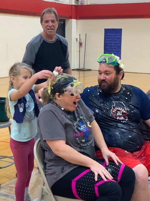 Picture of teachers having eggs cracked on their heads.  